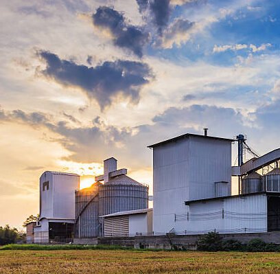 Grain Silo & Handling Equipment landscape shot rice mill with sunset background.